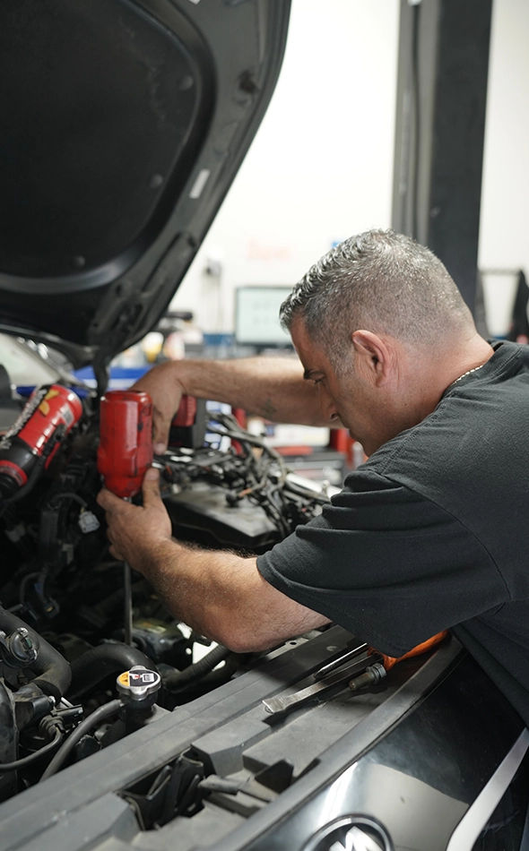 Mechanic Working on Car Engine at Auto Repair Shop Near Me