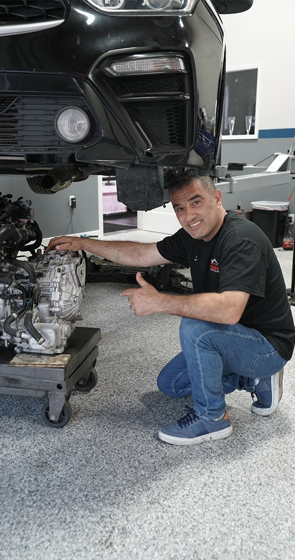 Mechanic Working on Engine at Auto Repair Shop Near Me