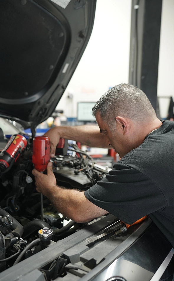 Mechanic Performing Auto Diagnostic Repair on a Car Engine