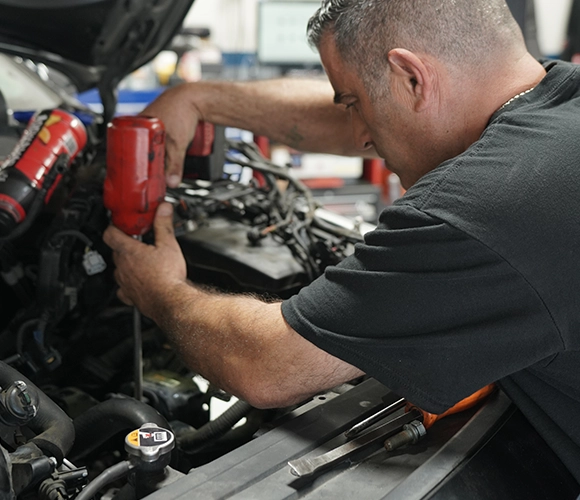 Mechanic Performing Auto Diagnostic Repair on Car Engine