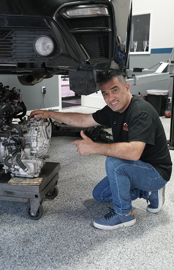 Mechanic Pointing at an Engine in an Auto Repair Shop