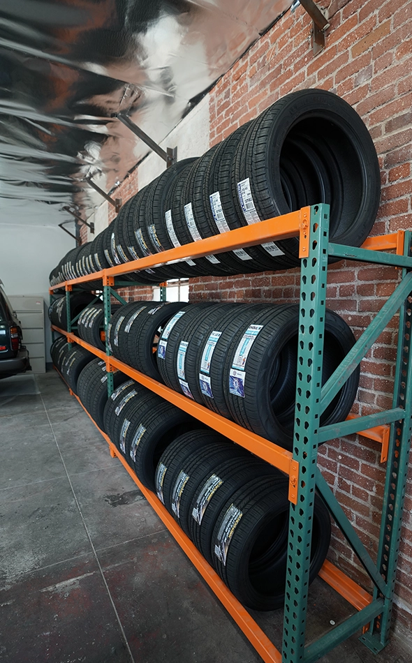 Tires Stacked on Shelves in Auto Repair Shop Garage